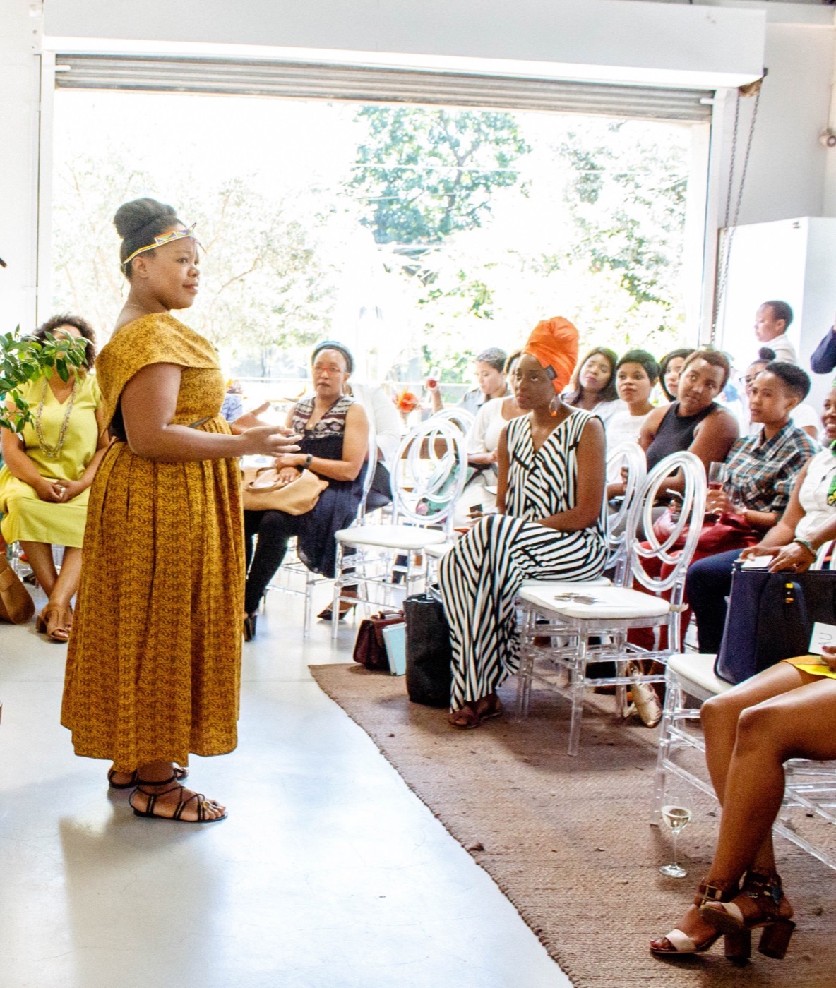 A facilitator speaking with a seated group
